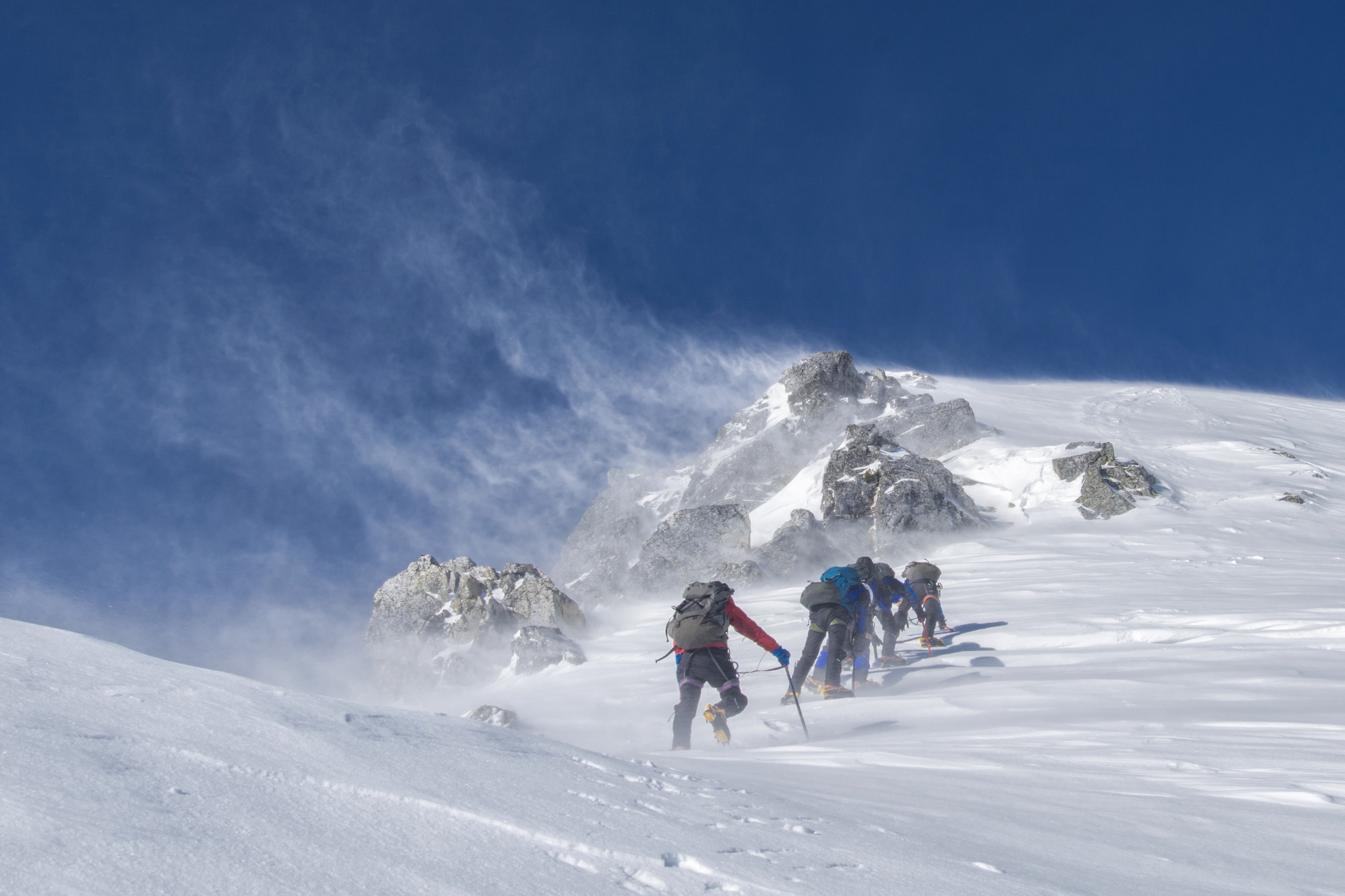 team climbing in the snow